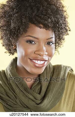 Portrait of an African American woman smiling with a stole round her neck over colored background View Large Photo Image Picture - Portrait of an African American woman smiling with a stole round her neck over colored background. Fotosearch