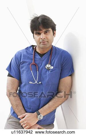 Portrait of an Indian male doctor leaning over white background View Large Photo Image Stock Image - Portrait of an Indian male doctor leaning over white background. Fotosearch