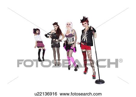 Stock Photograph - Portrait of beautiful all female band with microphone over white background. Fotosearch