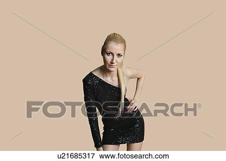 Stock Photo - Portrait of beautiful blond woman posing over colored background. Fotosearch