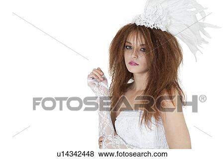 Stock Photo - Portrait of beautiful young brunette in wedding gown over white background. Fotosearch