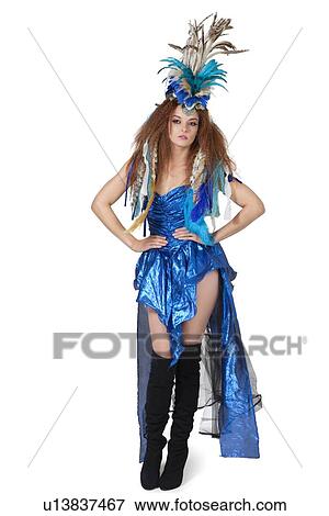 Stock Photo - Portrait of beautiful young fashion model posing with feather headgear over white background. Fotosearch