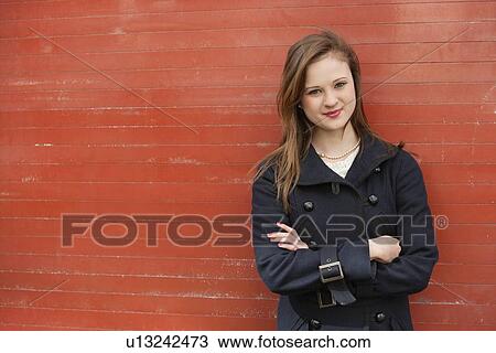 Portrait of beautiful young office worker standing with arms crossed View Large Photo Image Stock Image - Portrait of beautiful young office worker standing with arms crossed. Fotosearch