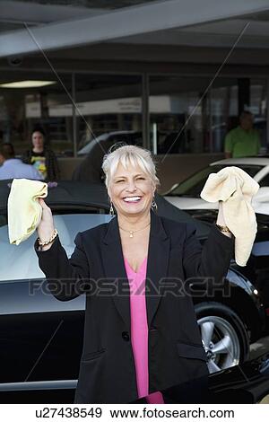 Portrait of cheerful female owner showing washcloth in car wash View Large Photo Image Stock Photo - Portrait of cheerful female owner showing washcloth in car wash. Fotosearch