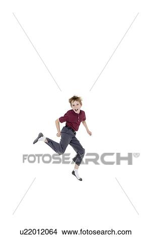 Portrait of cheerful pre-teen boy jumping over white background View Large Photo Image Picture - Portrait of cheerful pre-teen boy jumping over white background. Fotosearch