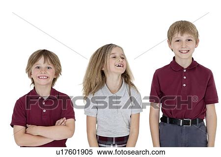 Stock Photography - Portrait of cheerful school children in uniform over white background. Fotosearch
