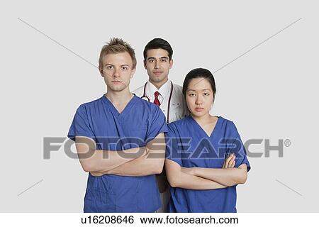 Portrait of confident healthcare workers standing over gray background View Large Photo Image Stock Photograph - Portrait of confident healthcare workers standing over gray background. Fotosearch