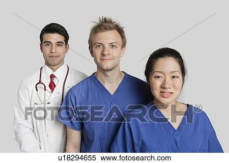 Portrait of diverse medical team standing over gray background View Large Photo Image Stock Photography - Portrait of diverse medical team standing over gray background. Fotosearch
