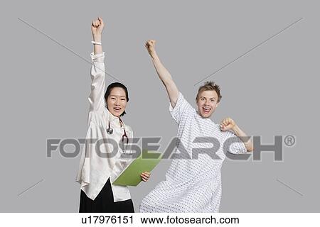 Portrait of doctor and patient cheering up with raised arms View Large Photo Image Stock Image - Portrait of doctor and patient cheering up with raised arms. Fotosearch
