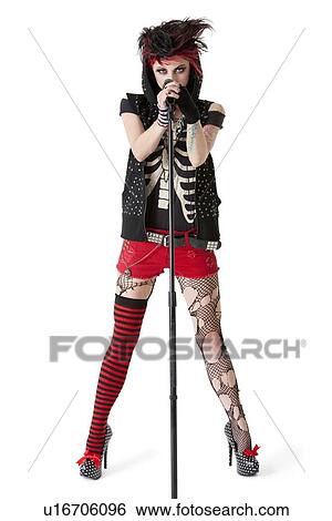 Portrait of female punk rock musician with microphone over white background View Large Photo Image Stock Photograph - Portrait of female punk rock musician with microphone over white background. Fotosearch