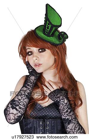 Stock Image - Portrait of gothic girl wearing headgear over white background. Fotosearch