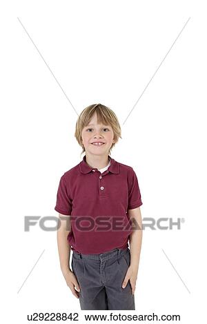 Portrait of happy elementary boy in school uniform over white background View Large Photo Image Stock Image - Portrait of happy elementary boy in school uniform over white background. Fotosearch