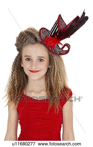 Stock Photo - Portrait of happy girl in red outfit and hat over white background. Fotosearch