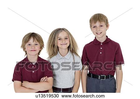 Portrait of happy school children in uniform over white background View Large Photo Image Stock Image - Portrait of happy school children in uniform over white background. Fotosearch