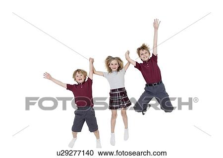 Portrait of happy school children holding hands while jumping over white background View Large Photo Image Stock Image - Portrait of happy school children holding hands while jumping over white background. Fotosearch