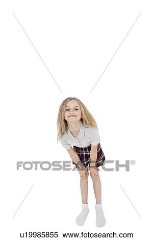 Portrait of happy school girl bending over white background View Large Photo Image Stock Photography - Portrait of happy school girl bending over white background. Fotosearch