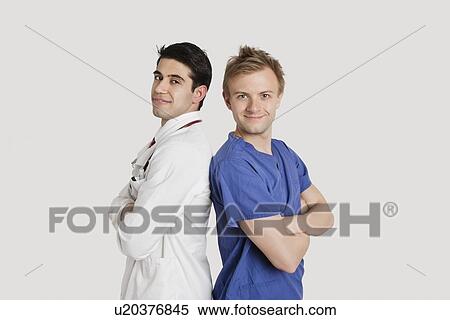 Portrait of healthcare professionals standing back to back over light gray background View Large Photo Image Stock Photography - Portrait of healthcare professionals standing back to back over light gray background. Fotosearch