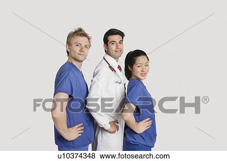 Portrait of medical team standing hands on hips over gray background View Large Photo Image Stock Photo - Portrait of medical team standing hands on hips over gray background. Fotosearch