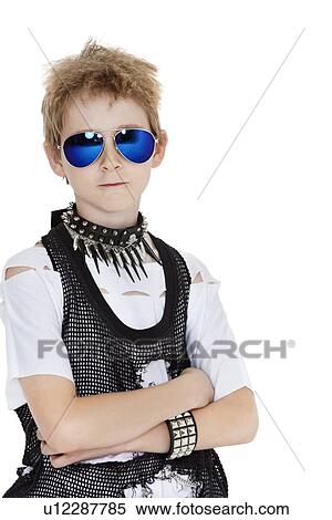 Stock Photography - Portrait of punk pre-teen boy wearing sunglasses with arms crossed over white background. Fotosearch