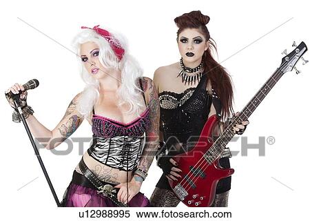 Stock Photography - Portrait of punk rock musicians with electric guitar and microphone over white background. Fotosearch