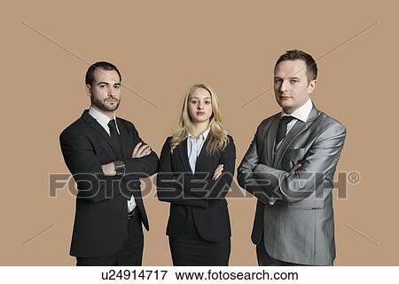 Portrait of young business people with arms crossed over colored background View Large Photo Image Stock Photo - Portrait of young business people with arms crossed over colored background. Fotosearch