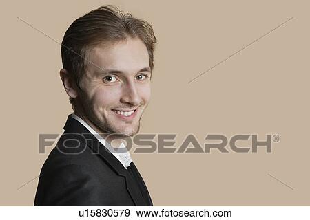 Portrait of young businessman smiling over colored background View Large Photo Image Stock Photo - Portrait of young businessman smiling over colored background. Fotosearch