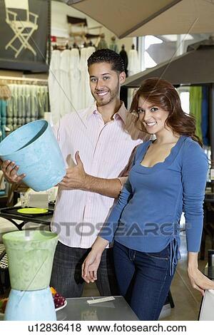 Portrait of young couple with a souvenir in store View Large Photo Image Stock Photo - Portrait of young couple with a souvenir in store. Fotosearch