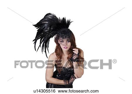 Portrait of young fashion model wearing feathered headdress over white background View Large Photo Image Stock Photograph - Portrait of young fashion model wearing feathered headdress over white background. Fotosearch