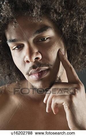 Portrait of young man with curly hair View Large Photo Image Stock Photo - Portrait of young man with curly hair. Fotosearch