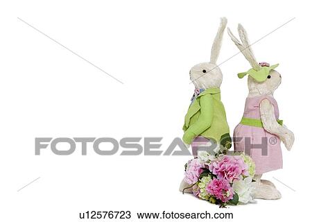Rabbit couple standing back to back with flower bouquet over white background View Large Photo Image Stock Image - Rabbit couple standing back to back with flower bouquet over white background. Fotosearch