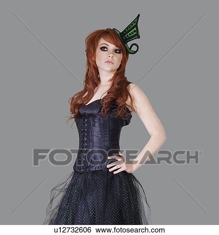 Stock Photograph - Redheaded teenage girl posing over gray background. Fotosearch