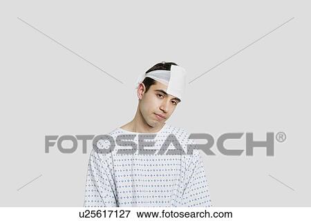 Stock Photo - Sad male patient with bandage on head. Fotosearch