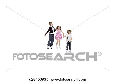 Stock Photography - School friends holding hands while jumping over white background. Fotosearch