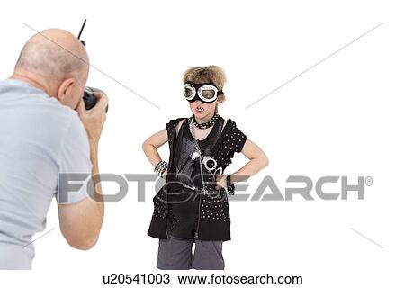 Stock Image - Senior adult photographer shooting punk kid over white background. Fotosearch