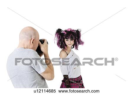 Stock Photography - Senior photographer in shooting fashion model over white background. Fotosearch