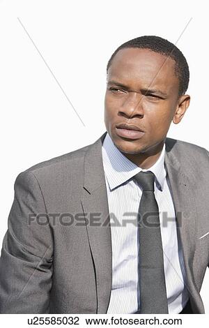 Serious African American businessman looking away over white background View Large Photo Image Stock Image - Serious African American businessman looking away over white background. Fotosearch