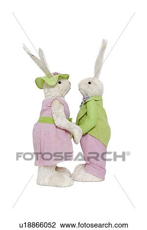 Stock Image - Side view of couple holding hands over white background. Fotosearch