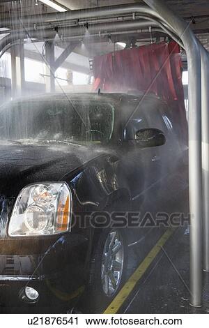 Spraying water on automobile in car wash View Large Photo Image Stock Image - Spraying water on automobile in car wash. Fotosearch