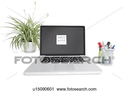 Stock Image - Sticky notepaper stuck on laptop screen in office. Fotosearch