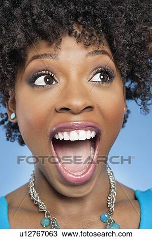 Surprised African American woman looking away with mouth open View Large Photo Image Stock Image - Surprised African American woman looking away with mouth open. Fotosearch