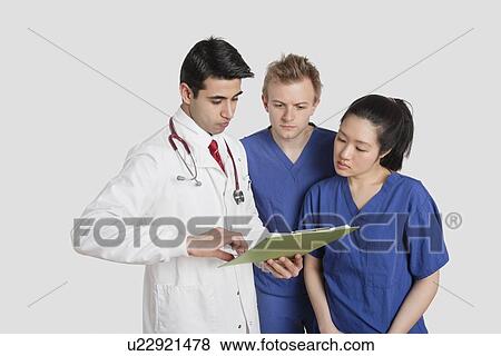 Stock Photo - Three healthcare professional discussing medical report over gray background. Fotosearch