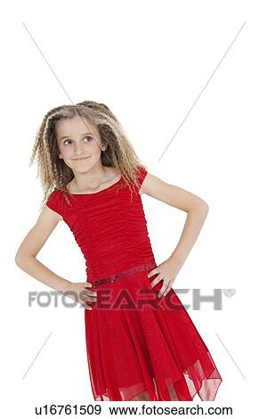 Stock Photo - Tilt image of girl in red frock with hands on hips over white background. Fotosearch
