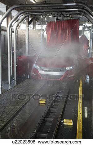 Vehicle on conveyor belt moving through car wash process View Large Photo Image Stock Photo - Vehicle on conveyor belt moving through car wash process. Fotosearch