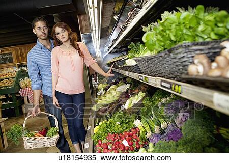 Young couple shopping for vegetables in supermarket View Large Photo Image Stock Photography - Young couple shopping for vegetables in supermarket. Fotosearch