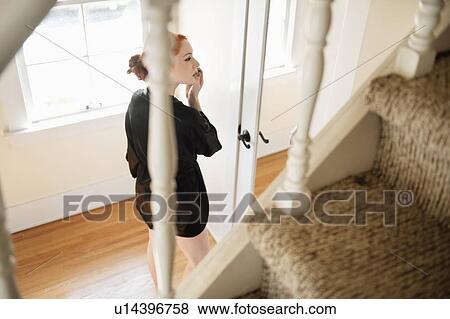 Stock Photo - Young female in bathrobe applying make-up. Fotosearch