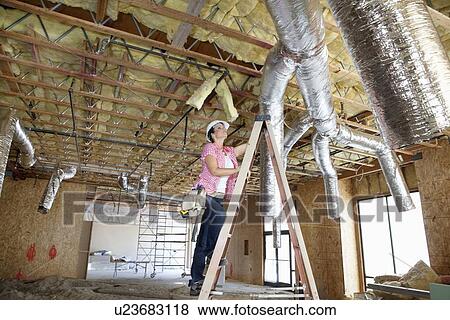 Young woman climbing up the ladder while looking at ceiling View Large Photo Image Stock Photo - Young woman climbing up the ladder while looking at ceiling. Fotosearch