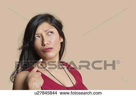 Young woman pointing over colored background View Large Photo Image Picture - Young woman pointing over colored background. Fotosearch
