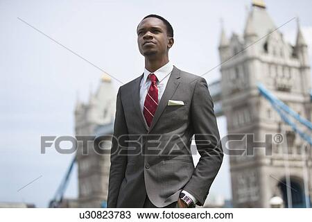 African American businessman standing against London Bridge View Large Photo Image Stock Image - African American businessman standing against London Bridge. Fotosearch