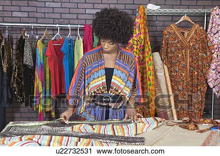 African American female designer measuring cloth at design studio View Large Photo Image Stock Image - African American female designer measuring cloth at design studio. Fotosearch