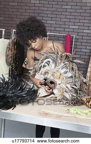 African American female fashion designer working on feather mask View Large Photo Image Picture - African American female fashion designer working on feather mask. Fotosearch